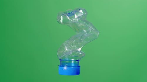 Plastic Crushed Water Bottle On Green Screen Background