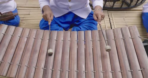 Musicians Playing a Wooden Xylophone with Mallets