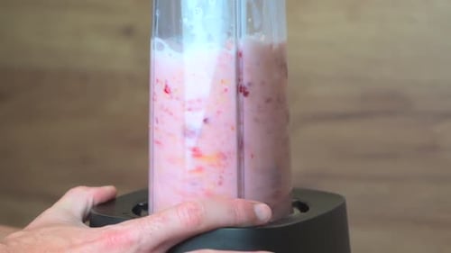 Slow Motion Video of Blender Mixing Milk Ice and Fruits for Smoothie