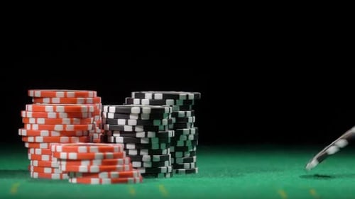 Casino Poker Chips on Green Table with Black Backdrop