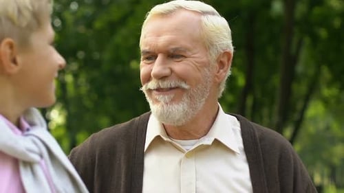 Mature Man and Child Embrace in Green Park