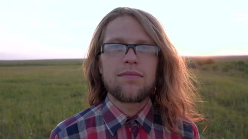 Young Adult Portrait in Open Field at Sunset