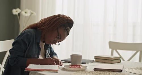 Young Adult Studying at a Table in a Home