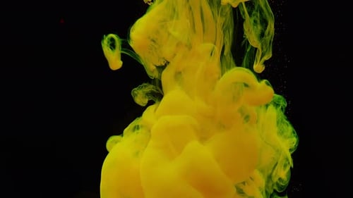 Swirling Yellow Ink Dropped Into Water