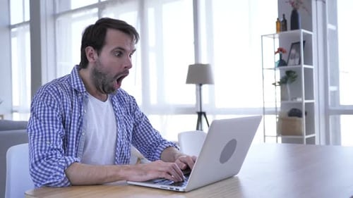 Casual Beard Man in Shock Working on Laptop