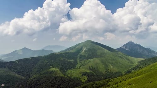 Beautiful Fast Clouds over Green Alpine Mountains Landscape in Sunny Summer Nature