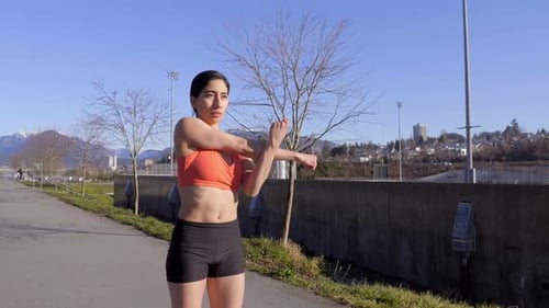 Athletic Woman Stretching in the Sun