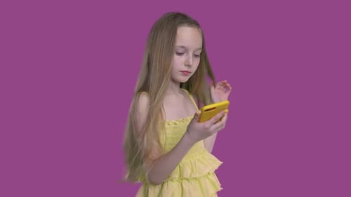 Girl Using Smartphone in Front of Purple Background