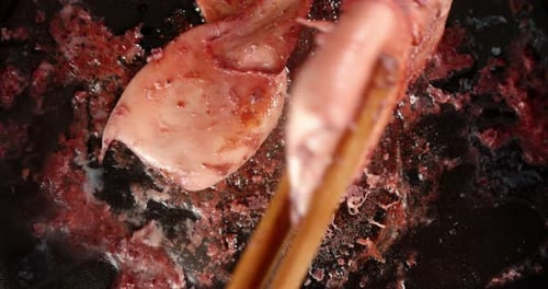 Squid Cooking with Chopsticks in a Pan