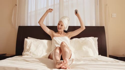 Woman with Cellphone in Bedroom