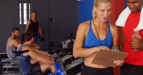 Gym Fitness Class Exercising With Trainer