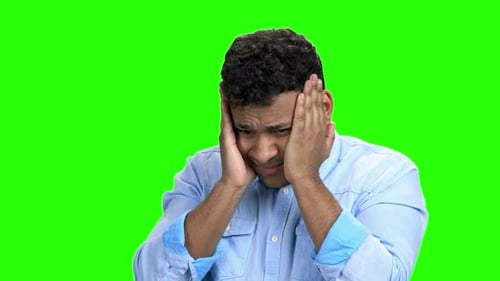Man Rubs Temples Suffering from Headache
