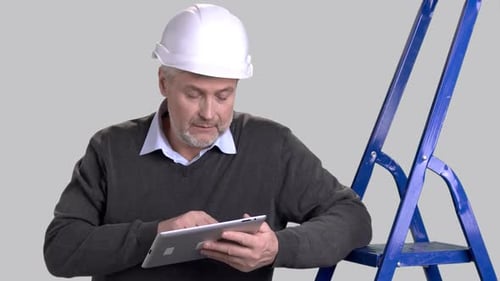 Caucasian Foreman Using Computer Tablet.