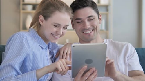 Couple Enjoys Tablet Together Indoors at Home