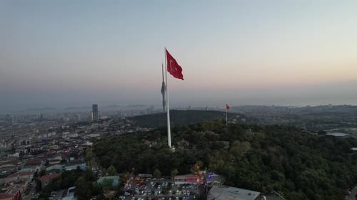 Cityscape Aerial View with Flag at Sunrise