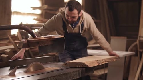 Man Working With Wood in a Workshop