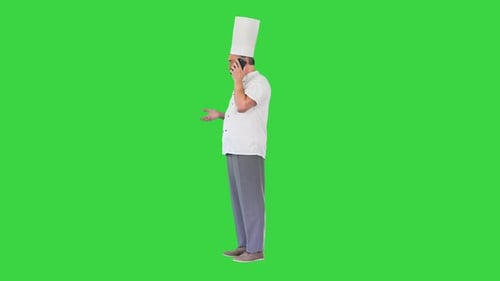 Male Chef Cook with Calling on Smartphone on a Green Screen Chroma Key