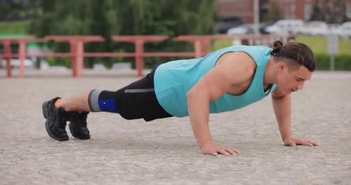 Man Doing Push-Ups in Urban Setting