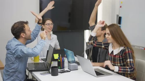Colleagues Celebrate Success at Modern Office Table