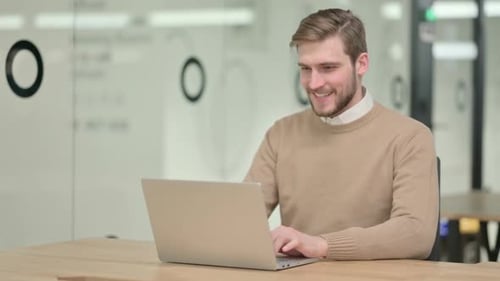 Young Man on Video Call Waving