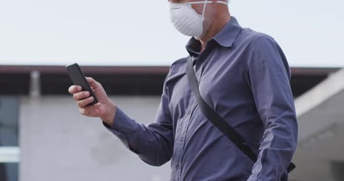 Caucasian man out and about in the street wearing on a face mask against coronavirus