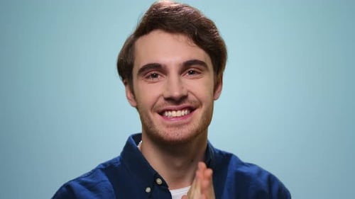 Excited Man Celebrating Success in Studio. Happy Guy Showing Yes Gesture