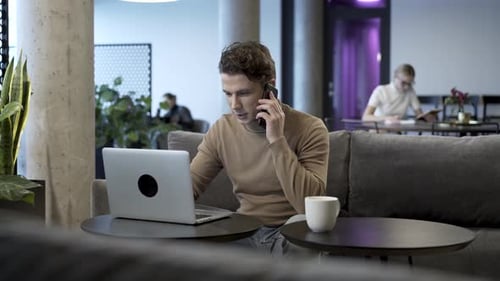 Freelance Business Specialist Having Mobile Phone Conversation