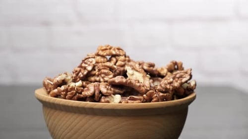 Wooden Bowl Filled with Walnuts on Countertop