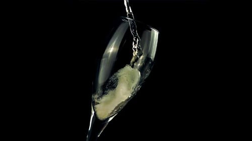 Sparkling Wine Being Poured Into a Champagne Glass
