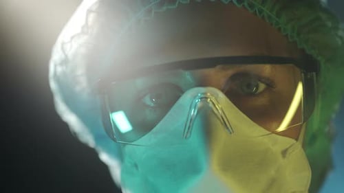 Portrait of a Female Doctor in Medical Uniform is Looking at Camera at Hospital Close Up