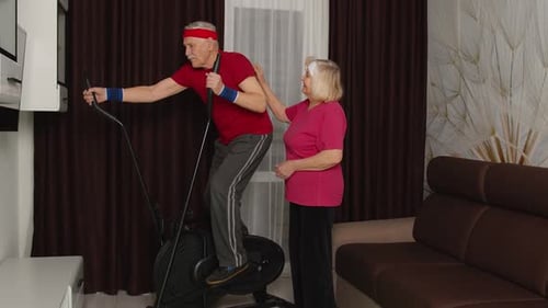 Active Senior Man Exercising on Elliptical with Support