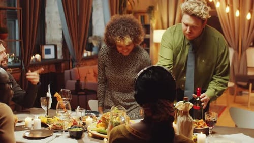 Friends Celebrating Together at Cozy Dinner Party