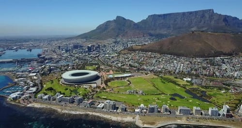 Sweeping Aerial View of City and Mountains