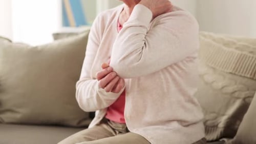 Senior Adult Rubbing Sore Elbow Indoors