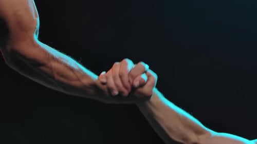 Rescue Concept. Hands of Two People During the Help. Slow Motion. Close Up.