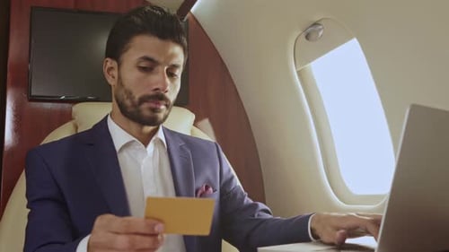 Man Works On Laptop In Private Jet