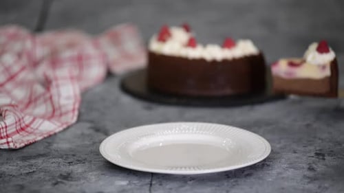 Piece of Chocolate Raspberry Cheesecake with Whipping Cream.