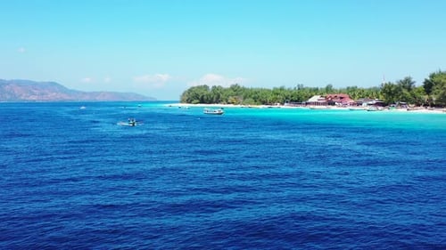 Aerial top view scenery of tropical tourist beach adventure by aqua blue lagoon with white sand back