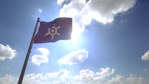 Waving Flag with Stylized Emblem Against Bright Sunny Sky