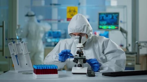 Scientist Working with Microscope in Modern Laboratory