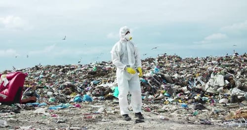 Person in Protective Suit at a Landfill