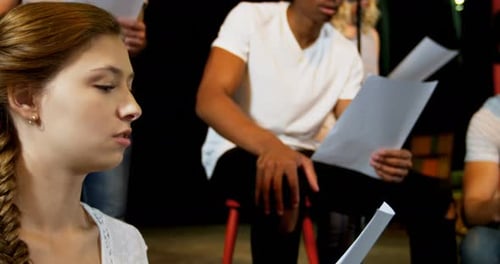 Young Adults Rehearse a Script for a Play