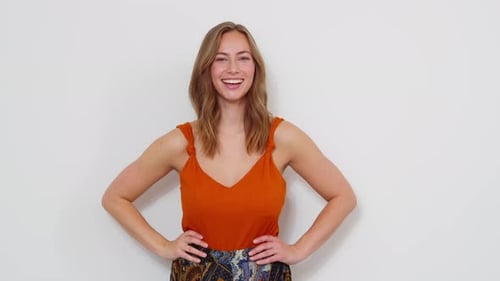 Stylish Woman Posing in Front of White Wall