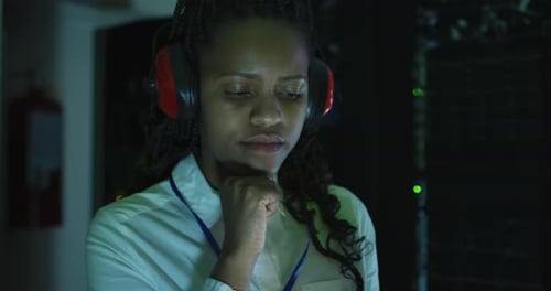 Woman Works in Dark Data Center Server Room