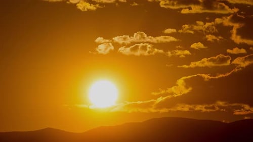 Golden Sunrise with Rolling Hills and Clouds