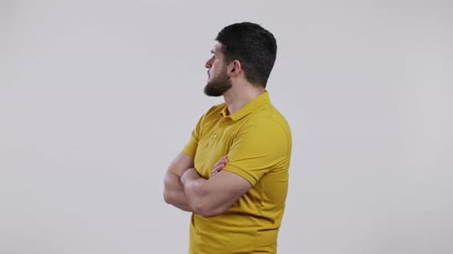 Angry Offended Man Keeping Arms Crossed and Staring at Camera with Sceptical and Distrustful Look