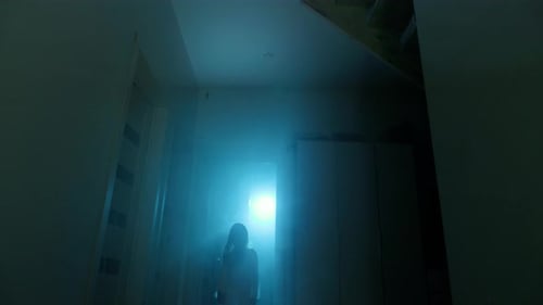 Eerie Figure Glowing in Dark Hallway