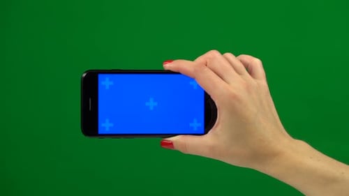 Blue Screen Smartphone in Hands. Green Screen