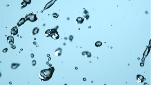 Falling Water Droplets in Slow Motion on Blue