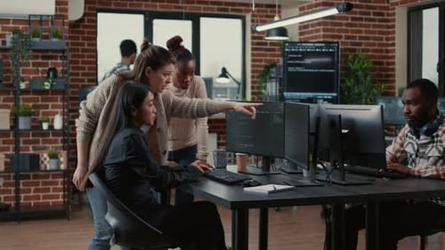 Mixed Team of Software Engineers Brainstorming Ideas for New Code Library in Front of Computer